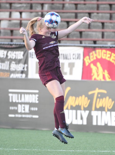 Detroit City FC's Lilian Lucas heads the ball upfield in the first half.