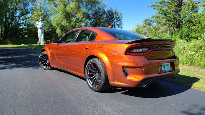 The 2020 Dodge Charger Scat Pack Plus shows off its distinctive Sinamon Stick red color.