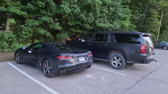 The 2020 Chevy Corvette is the sports car of the Chevy family. Here it parks next to big brother Chevy Suburban.