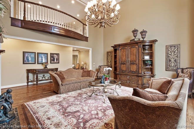 A Tuscan estate in Washington Township designed with over 12,000 square feet of living space features dramatic ceilings, hardwood and marble floors, motorized chandeliers, extra large windows and custom artist details throughout.