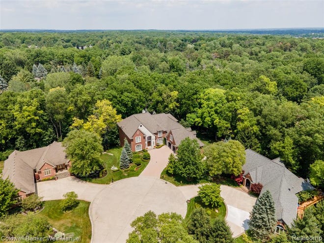 A Tuscan estate in Washington Township designed with over 12,000 square feet of living space features dramatic ceilings, hardwood and marble floors, motorized chandeliers, extra large windows, and custom artist details throughout