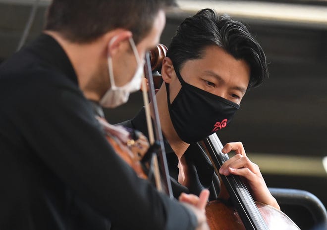 Wei Yu on cello performs during the Detroit Symphony Orchestra 'Outdoor Performance Series' at Sosnick Courtyard in Detroit, Michigan on August 5, 2020.