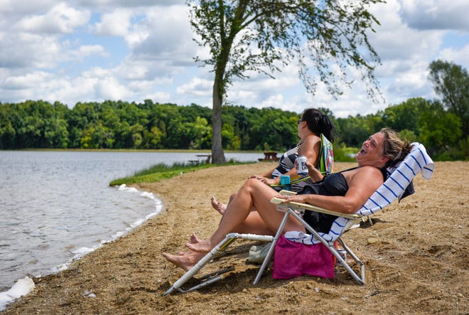 Sisters Patty Stone, Waterford, left, and Jackie Lewis, Warren, right, relax on the beach at Greenwood Acres Family Campground in Jackson, Michigan, Wednesday, August 5, 2020. The property was the site of the Goose Lake International Music Festival August 7-9, 1970. The pair remember being there as young children.
