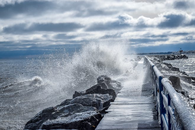 Trish DeFrain of Port Huron caught a northern wind driving and angry Lake Huron into the pier at Lexington Harbor on New Year's Day.