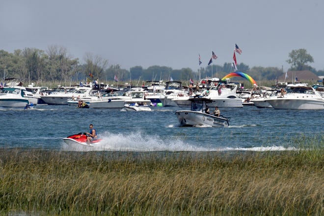 St. Clair Shores Sheriff's deputies patrol the area as boaters enjoy the festivities of the annual Raft Off, located on Little Muscamoot Bay.