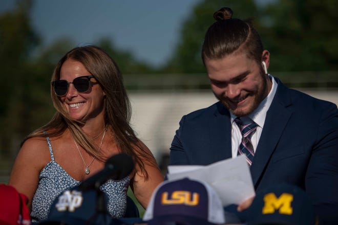 Rochelle Spindler, left, smiles as her son, Rocco Spindler, talks about her during his college decision choice at Clarkston High School in Clarkston on Aug. 8, 2020.