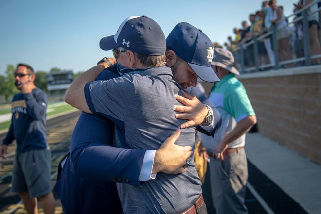 Rocco Spindler, left, embraces Clarkston football head coach Kurt Richardson after Rocco Spindler’s commitment to Notre Dame during his college decision choice at Clarkston High School in Clarkston, Mich. on Aug. 8, 2020. (Nic Antaya, Special to The Detroit News)