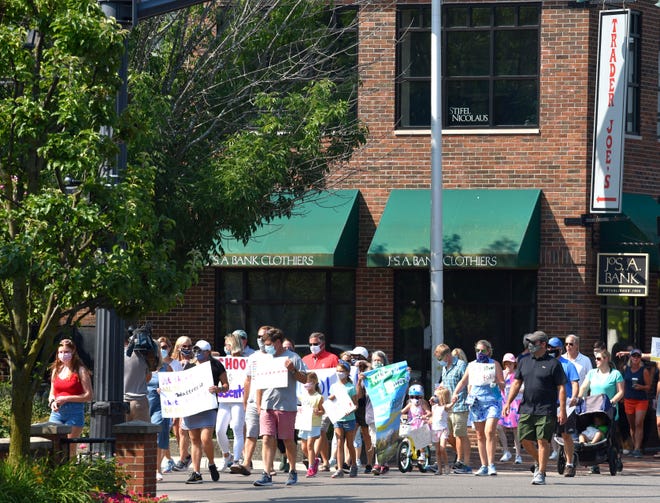 More than 100 people who support the option of face-to-face learning march through the Village of Grosse Pointe, Sunday morning, August 9, 2020.