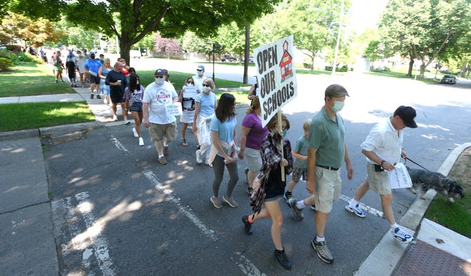 People march to support the option of face-to-face learning, Sunday morning in the village of Grosse Pointe.