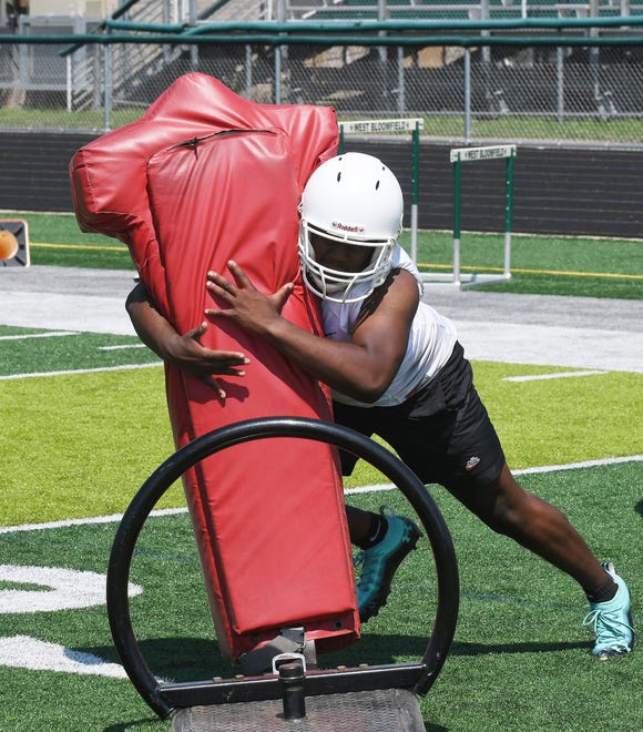 West Bloomfield linebacker Carson Stewart hits the sled during drills.