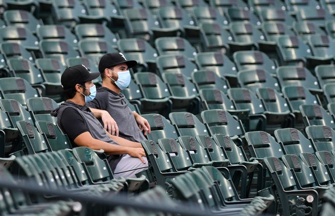 Chicago White Sox players watch in the first inning from the stands.