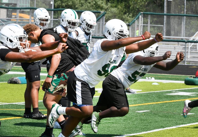 West Bloomfield's defense work busting off the line during drills.