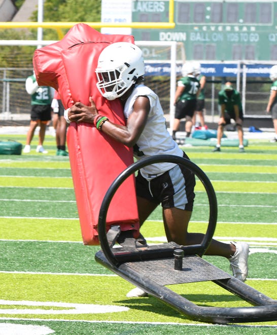 West Bloomfield safety B.J. Rankin hits the sled during drills.