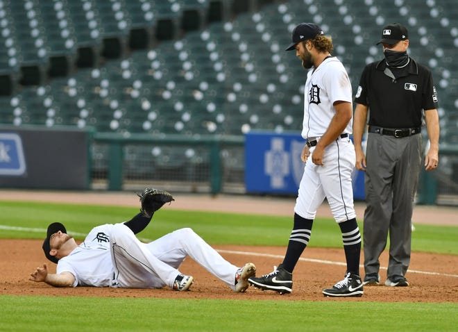 Tigers pitcher Daniel Norris, right, checks on first baseman C.J. Cron in pain in the fourth inning on Monday night.