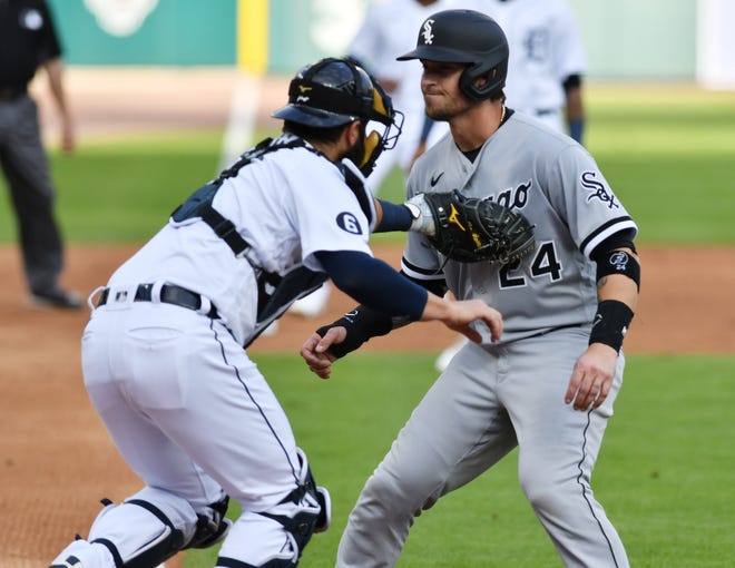 Tigers catcher Austin Romine tags out Chicago's Yasmani Grandal in the first inning.