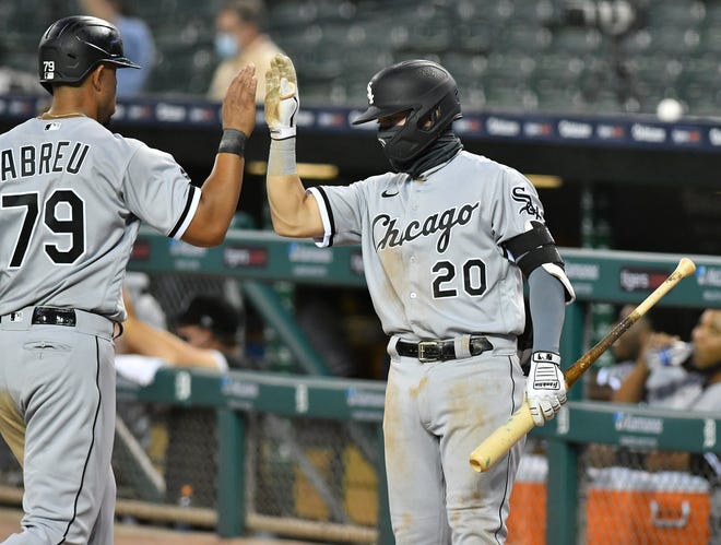 Chicago's Danny Mendick (20) congratulates Jose Abreu after Abreu scores in the sixth inning.  Detroit Tigers vs Chicago White Sox at Comerica Park in Detroit on Aug. 11, 2020.