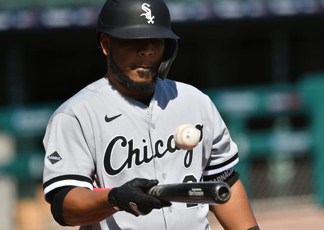 White Sox designated hitter Edwin Encarnacion plays with a ball before turning it over to the bat boy in the ninth inning.