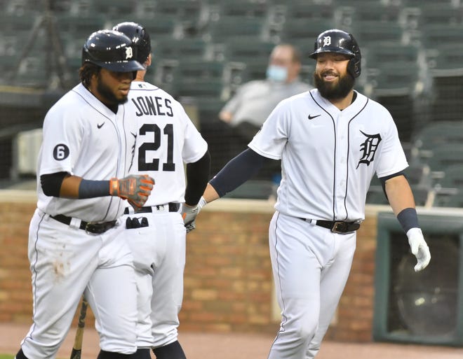 Tigers' Austin Romine, right, reacts with JaCoby Jones (21) after Romine hits a two-run home run scoring Dawel Lugo, left, in the fifth inning.