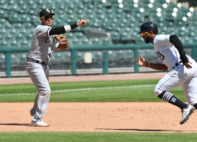 The Tigers' Willi Castro, right, is left on base after White Sox third baseman Ryan Goins makes the out at first in the seventh inning.