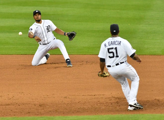 Tigers first baseman Jeimer Candelario throws to pitcher Rony Garcia going to cover first base in the fifth inning.