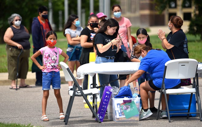 The Rosas family signs in at the Summer on the Block event in the Western High School parking lot.