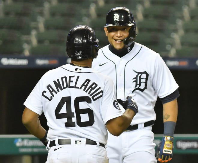 Tigers' Miguel Cabrera and Jeimer Candelario (46) react after they both score on a double by Niko Goodrum in the sixth inning to make it 6-3 Tigers.