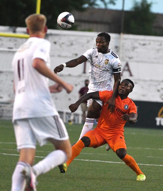DCFC's Ibrahim Conteh goes over New Amsterdam FC's Yusuf Mikaheel going after the ball in the first half.