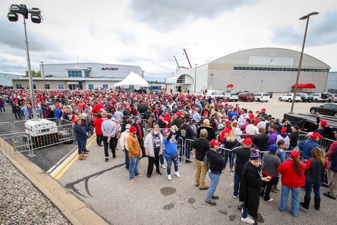 A large crowd queues outside the entrance to the Trump rally. President Donald Trump makes a campaign stop at an airplane hangar in Freeland, Michigan on Thursday, September 10, 2020.