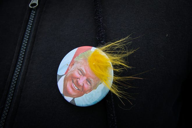A Donald Trump supporter wears a Trump “hair” button outside a rally in Freeland, Michigan on Thursday, September 10, 2020.