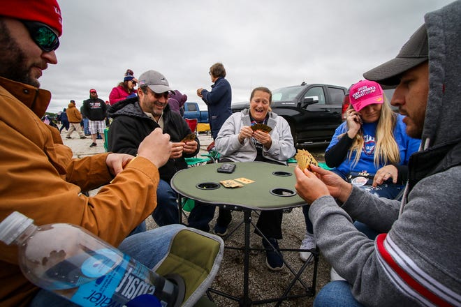 Playing rummy with Trump cards as they wait to get into a rally are from left: Nick Switala, Cass Shultz, Ann Christian, Stephanie Brewster, and Fred Lopez. President Donald Trump is scheduled to make a campaign stop at an airplane hangar in Freeland, Michigan on Thursday, September 10, 2020.