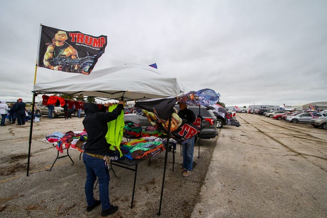 Trump flags fly against the gloomy skies ahead of a rally for President Donald Trump at a campaign stop at an airplane hangar in Freeland, Michigan, Thursday, September 10, 2020.