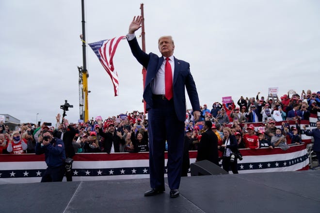 President Donald Trump waves as he arrives for a campaign rally at MBS International Airport, Thursday, Sept. 10, 2020, in Freeland, Mich.