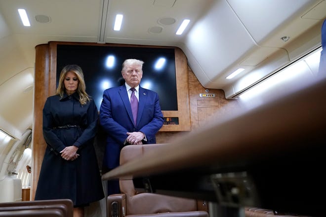 President Donald Trump and first lady Melania Trump pause for a moment of silence on Air Force One as he arrives at the airport in Johnstown, Pa., on his way to speak at the Flight 93 National Memorial, Friday, Sept. 11, 2020, in Shanksville, Pa.
