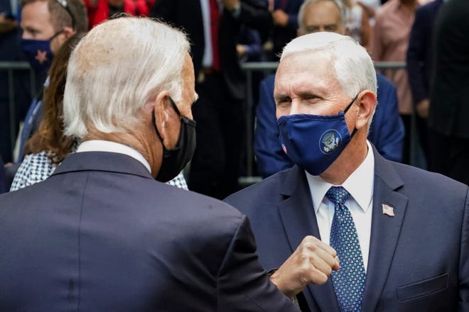 Democratic presidential candidate and former Vice President Joe Biden, left, greets Vice President Mike Pence, right, at the National September 11 Memorial and Museum, Friday, Sept. 11, 2020, in New York. Americans will commemorate 9/11 with tributes that have been altered by coronavirus precautions and woven into the presidential campaign.