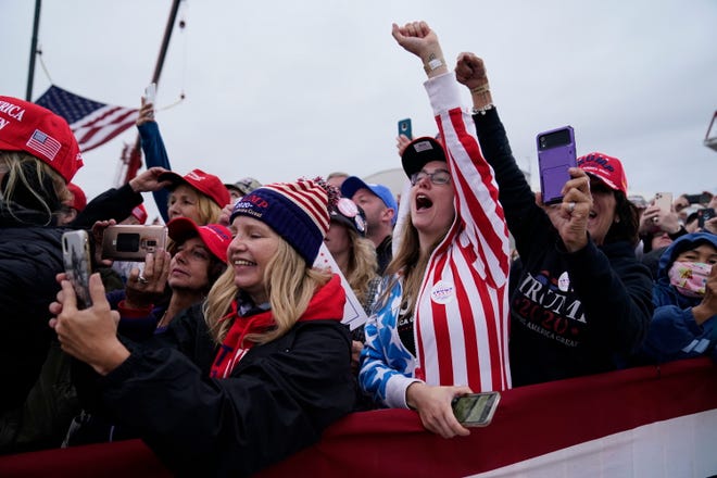 Supporters of President Donald Trump cheer as he arrives for a campaign rally at MBS International Airport, Thursday, Sept. 10, 2020, in Freeland, Mich.