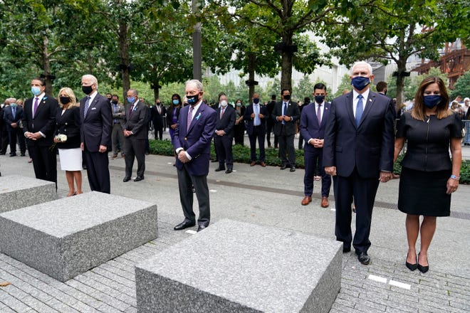 From left, New York Gov. Andrew Cuomo, Jill Biden with her husband Democratic presidential candidate and former Vice President Joe Biden, former NYC Mayor Mike Bloomberg, Vice President Mike Pence and his wife Karen, observe a moment of silence on Friday, Sept. 11, 2020, in New York.  The names of nearly 3,000 victims of the Sept. 11, 2001 terror attacks will be read by family members.