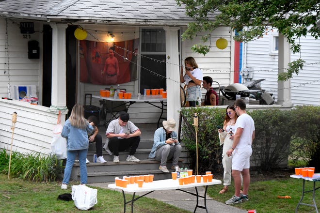 Students and friends gather at a house on Linden St.  off the MSU campus in East Lansing Saturday.