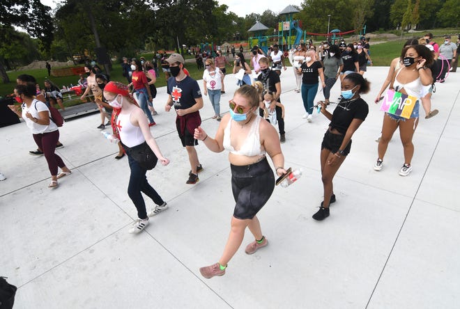 Participants dance while using social distance during the 2020 Detroit Slutwalk held at Palmer Park.