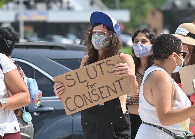 A participant carries a sign during the 2020 Detroit Slutwalk held at Palmer Park in Detroit on Saturday, September 12, 2020.