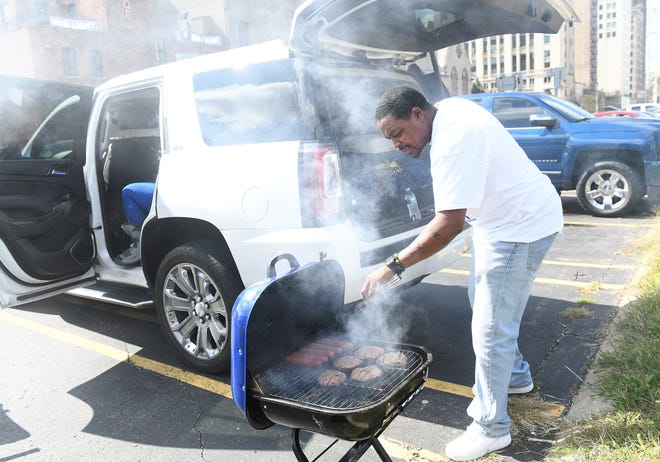 John Haynes, 46, of Detroit tends to the grill before the game.  Detroit Lions vs Chicago Bears at Ford Field in Detroit on Sept. 13, 2020.
