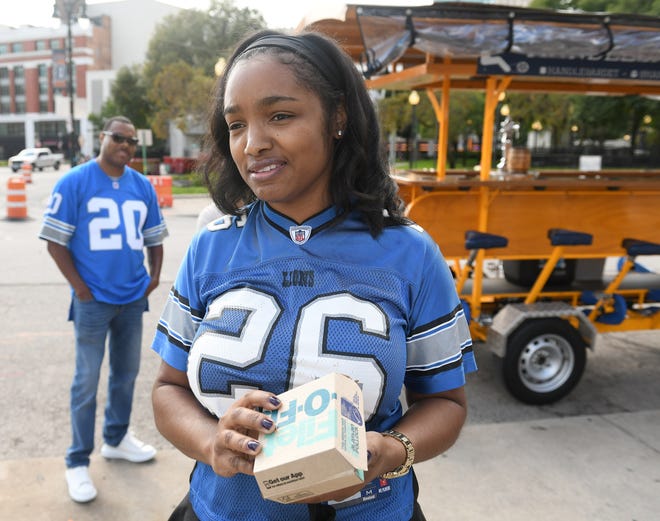 Kiesha Smith, 40, of Detroit talks about gathering with her family downtown for the Lions home opener. They were about to ride the handle bar trolley. Detroit Lions vs Chicago Bears at Ford Field in Detroit on Sept. 13, 2020.
