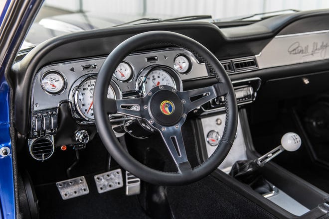 Interior: Leather wrapped aluminum steering wheel with signature Shelby gauges