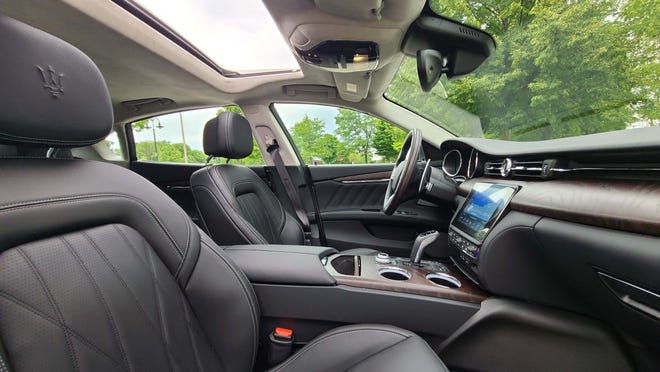The spacious interior of the 2020 Maserati Quattroporte S Q4 includes a sunroof, monostable shifter and lots of wood.