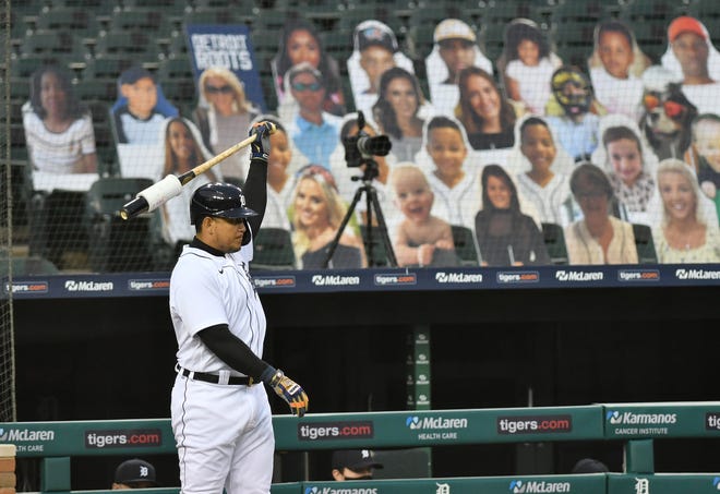 Tigers designated hitter Miguel Cabrera on deck in front of cutout fans in the first inning.