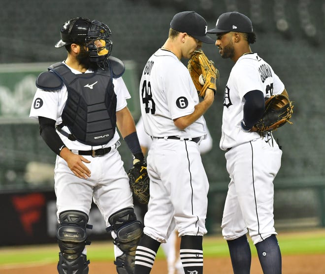 From left, Tigers catcher Austin Ronnie heads back to home while pitcher Matthew Boyd talks with second baseman Niko Goodrum in the third inning.