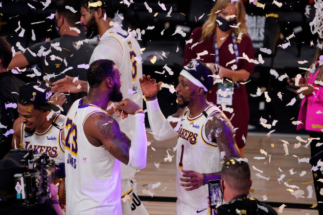 The Los Angeles Lakers' LeBron James (23) and Kentavious Caldwell-Pope (1) celebrate after the Lakers defeated the Miami Heat in Game 6.