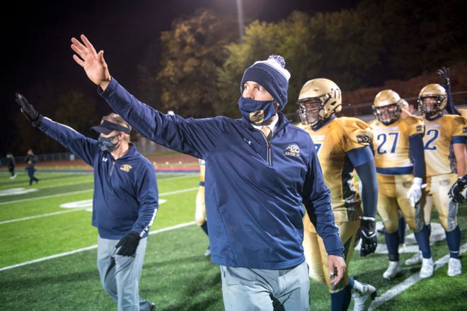 Rochester Hills Stoney Creek coaching staff wave to Southfield AT&T after winning after the high school football game at Southfield High School in Southfield.