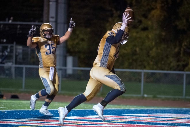 Rochester Hills Stoney Creek tight end Cole Luhmann (35) and Joseph Murray (27) celebrate a touchdown during the second quarter at Southfield A&T High School on October. 16, 2020.