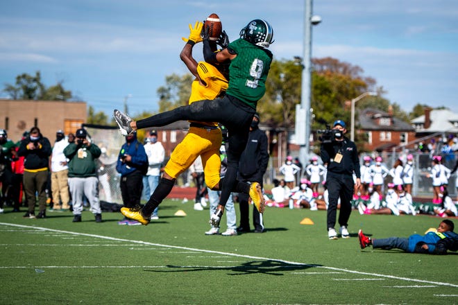 Cass Tech junior Jameel Gardner (9) receives a pass while being covered by Detroit King junior Lynn Wyche-EL (6).