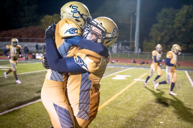 Rochester Hills Stoney Creek’s Brendan Davis (26) and Aden Smith (65) celebrate their win against Southfield AT&T.
